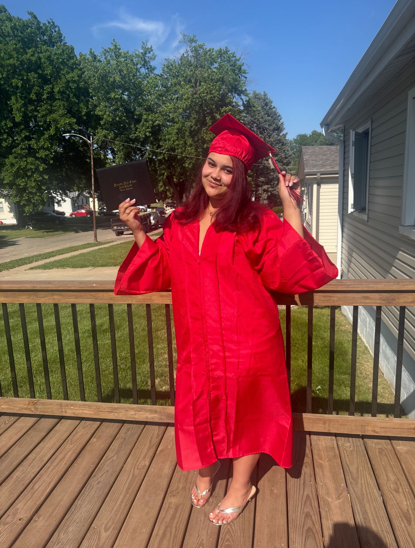 Ava in her red graduation robe Ava in her red graduation robe